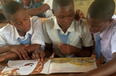 Children read giraffe-themed education materials_Wild Nature Institute
