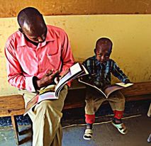 Teacher and Student Reading Wild Nature Institute's Lucky The Wildebeest book