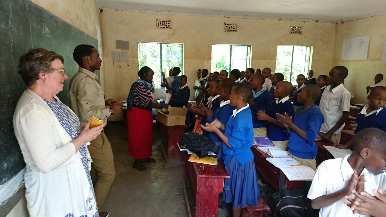  Wild Nature Institute's Lise and MAA's Lais (1st and 2nd from left) deliver books and posters to Mto Wa Mbu primary school. Wild Nature Institute