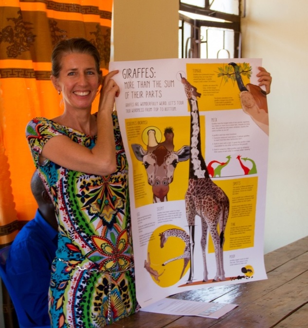 Picture of Wild Nature Institute's Monica Bond shows the giraffe poster, Wild Nature Institute